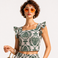 A woman wearing a green and white EVERSHE damask-patterned ruffle-sleeve crop top and matching bottoms, styled with orange-tinted sunglasses and a gold chain handbag against a plain white background.